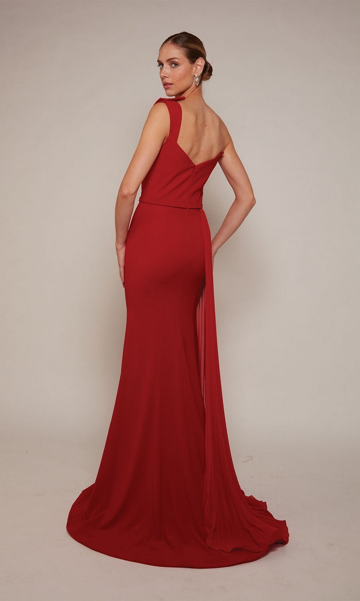 A woman poses with her back to the camera against a plain background, wearing the Long Formal Dress: Alyce 27650, a floor-length sleeveless evening gown featuring a fitted bodice.